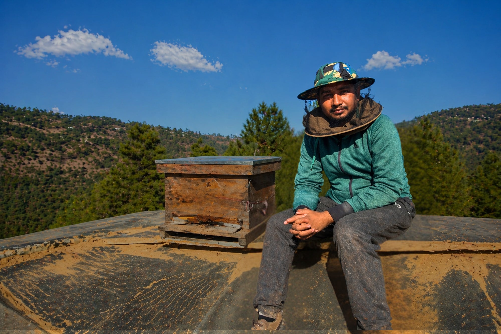 Himalayan beekeeper with natural wood hive in Uttarakhand forest — Real Raw Rare best honey in India Pahari Haat