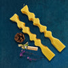 Geometrical beeswax candles glowing warmly — elegant Himalayan candles for gifting.